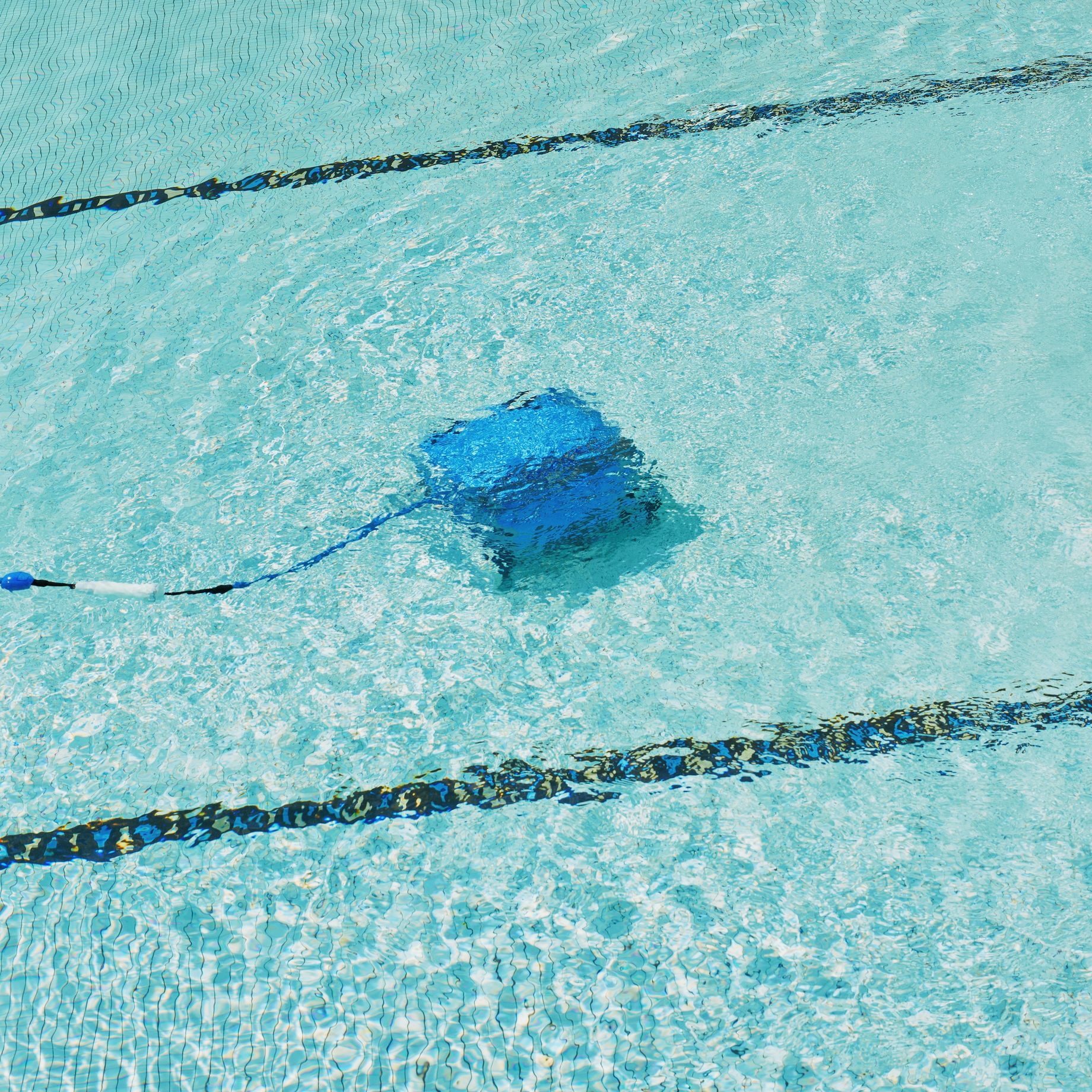 Robotic pool vacuum cleaning the pool floor